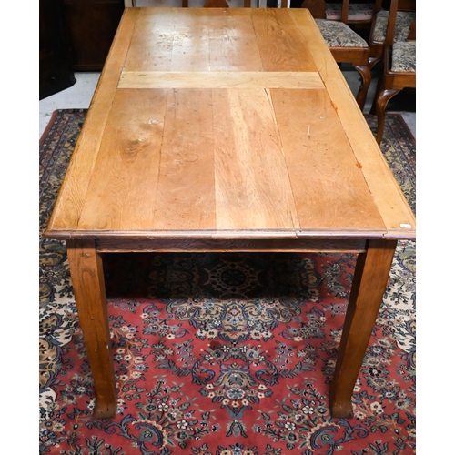 245 - A small oak dining table raised on square tapering legs, 179 cm x 87 cm x 73 cm h