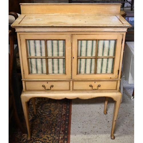 239 - A vintage Italian painted cabinet, with glazed doors over two drawers and raised on cabriole support... 