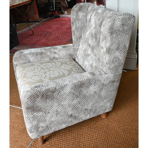 255 - A contemporary grey/brown upholstered armchair, raised on beech legs