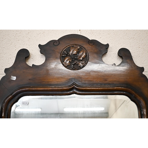 379 - A fret cut walnut framed wall mirror with bevelled plate in the Georgian manner, 58 cm wide x 125 cm... 