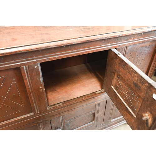 382 - An 18th century oak pantry cupboard of panelled construction with two small doors, 102 cm wide x 40 ... 