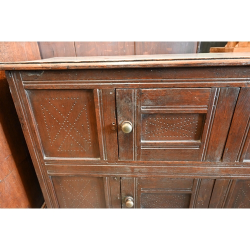 382 - An 18th century oak pantry cupboard of panelled construction with two small doors, 102 cm wide x 40 ... 