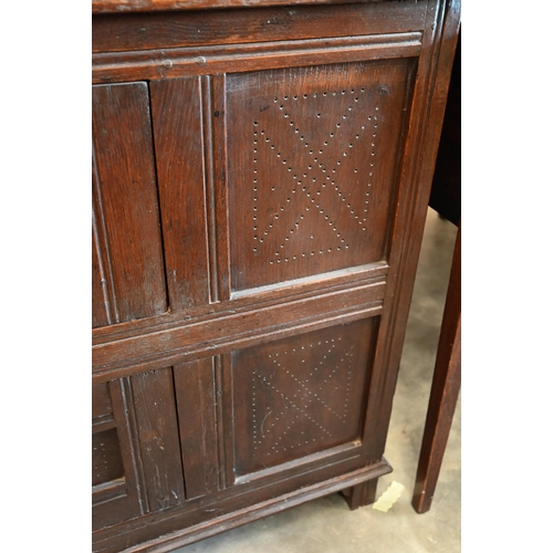 382 - An 18th century oak pantry cupboard of panelled construction with two small doors, 102 cm wide x 40 ... 