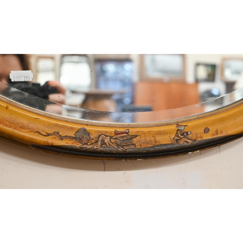 393 - A bevelled oval wall mirror in Japanned polychrome frame, 64 cm wide x 48 cm high