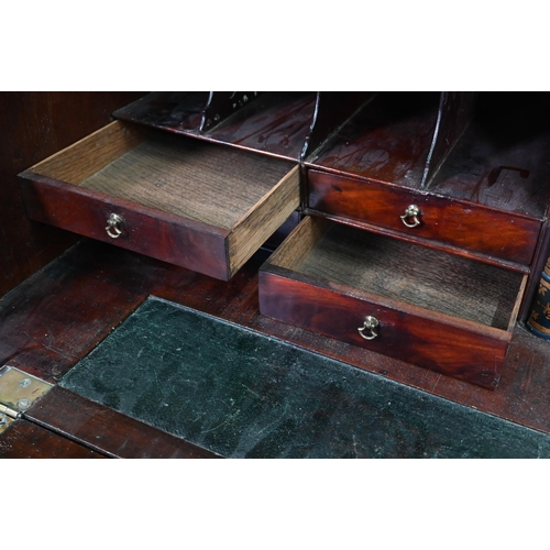 469 - A George III mahogany bureau, the well fitted interior with leather faux book spine 'secret' storage... 