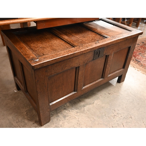 476 - An antique oak blanket chest/ coffer of panelled construction with hinged top, 105 cm wide x 54 cm d... 