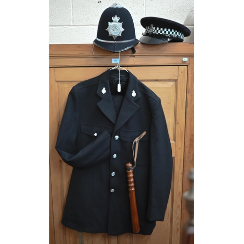 140 - A North Yorkshire policeman's uniform comprising helmet, peaked cap, tunic, trousers and truncheon