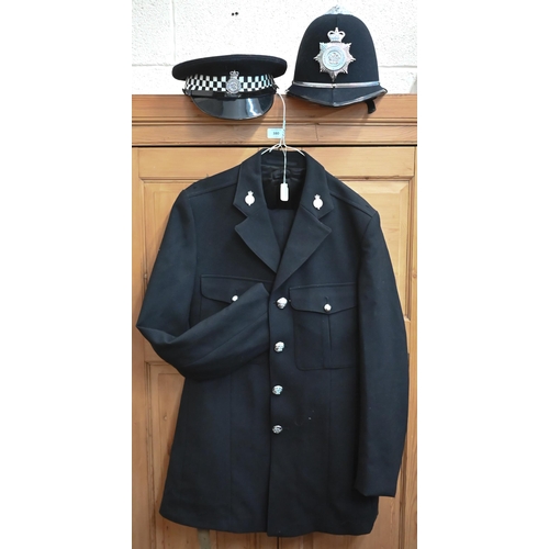 140 - A North Yorkshire policeman's uniform comprising helmet, peaked cap, tunic, trousers and truncheon