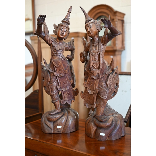 141 - Two Burmese carved wood figures of Temple dancers, 66 cm high