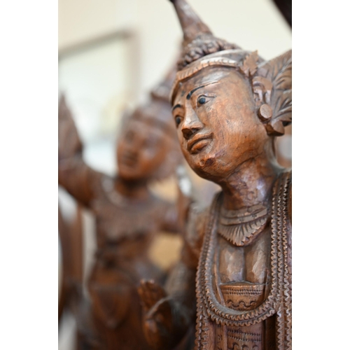 141 - Two Burmese carved wood figures of Temple dancers, 66 cm high