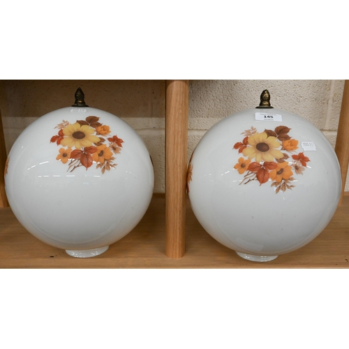 145 - Two globular glass ceiling lightshades with floral-printed decoration