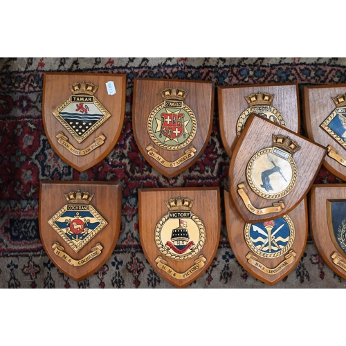 173 - Ten Royal Naval ship's badges on oak shields, to/w a Royal Marines Badge