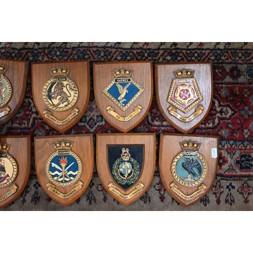 173 - Ten Royal Naval ship's badges on oak shields, to/w a Royal Marines Badge