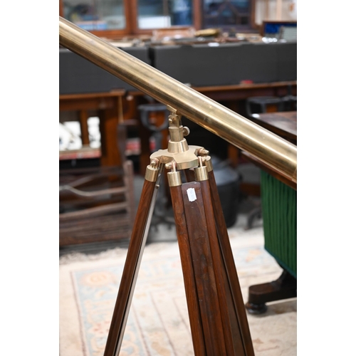 176 - A reproduction brass telescope, 100 cm long, on adjustable wooden tripod