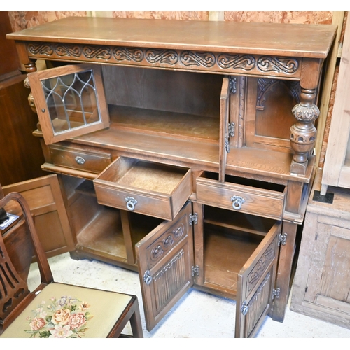 199 - A vintage Old Charm part lead glazed and linenfold panelled carved oak court cupboard, 138 cm x 47 c... 