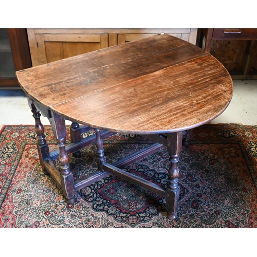 200 - An antique oak gateleg table with single drawer to one end, later toes, 107 cm (136 cm open) x 46 cm... 