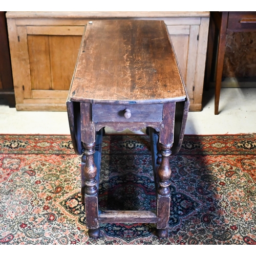 200 - An antique oak gateleg table with single drawer to one end, later toes, 107 cm (136 cm open) x 46 cm... 