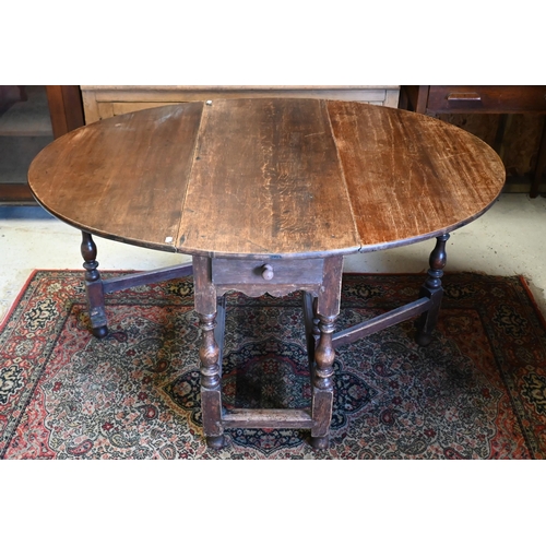 200 - An antique oak gateleg table with single drawer to one end, later toes, 107 cm (136 cm open) x 46 cm... 