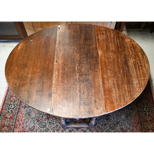 200 - An antique oak gateleg table with single drawer to one end, later toes, 107 cm (136 cm open) x 46 cm... 