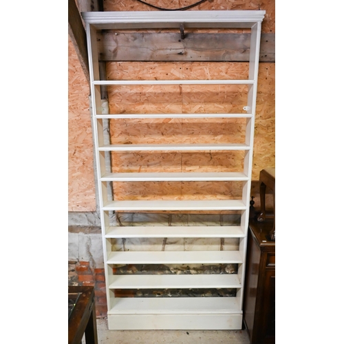 210 - A narrow painted (pine ?) nine shelf open bookcase, 110 cm x 17 cm x 227 cm