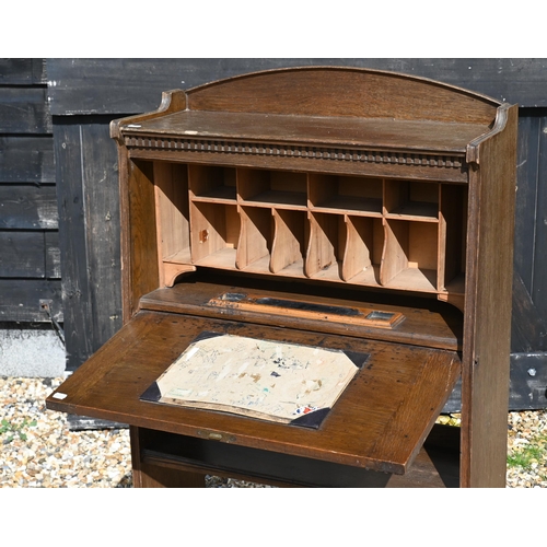 212 - An Art Nouveau period oak fall front student bureau, open shelves below, 71 cm x 25 cm x 122 cm h