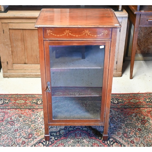 215 - A Sheraton revival inlaid satinwood music cabinet, with single glazed door, on square spade end legs... 