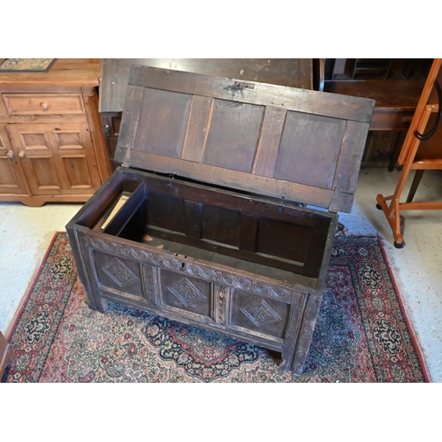 228 - A late 17th/18th century park carved oak coffer, raised on stile feet, 120 cm x 51 cm x 60 cm h