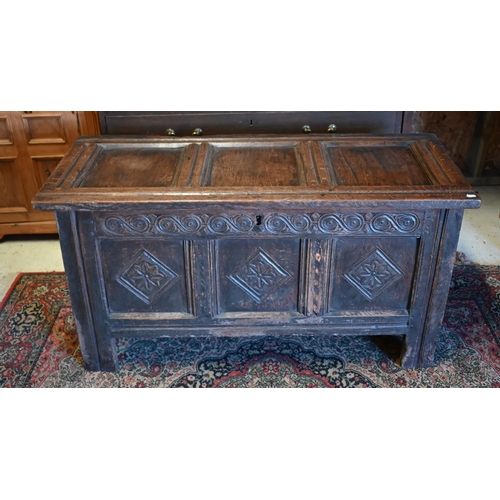 228 - A late 17th/18th century park carved oak coffer, raised on stile feet, 120 cm x 51 cm x 60 cm h