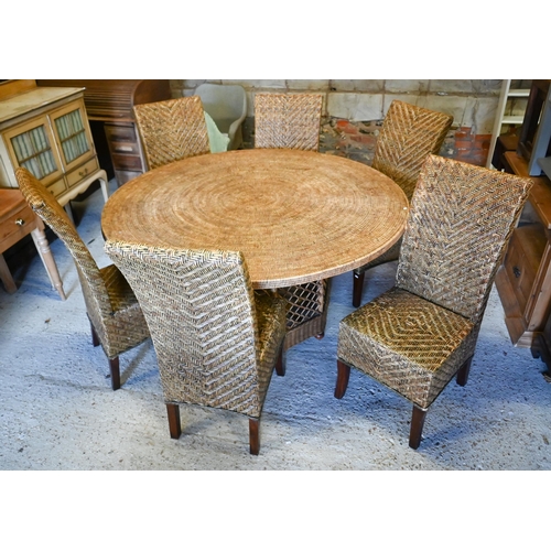 An Oka Beaumont all-weather rattan circular table, 150 cm dia. x 75 cm h to/with six similar chairs (not Oka)
