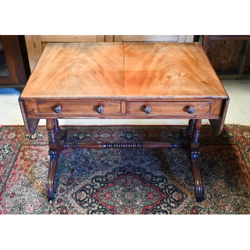 231 - A Georgian mahogany sofa table, the drop end top over two frieze drawers opposing dummy drawer front... 