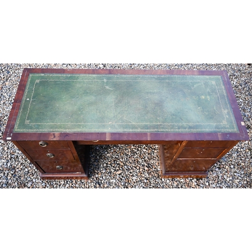 249 - An Edwardian mahogany desk with green leather-top over seven drawers, on plinths, 139 cm x 54 cm x 7... 