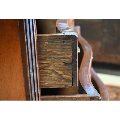 251 - A reproduction cross-banded walnut small serpentine form four drawer chest, with brush slide, 63 cm ... 