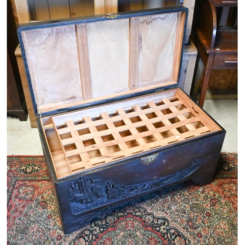 256 - A 1930's Chinese stained and carved camphorwood trunk, with original tray to the interior and brass ... 