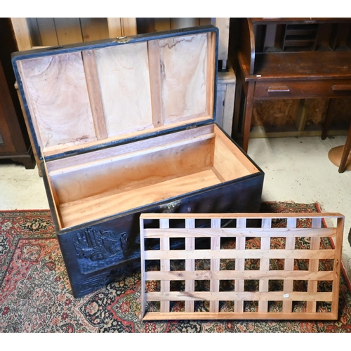 256 - A 1930's Chinese stained and carved camphorwood trunk, with original tray to the interior and brass ... 