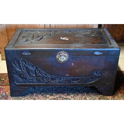 256 - A 1930's Chinese stained and carved camphorwood trunk, with original tray to the interior and brass ... 