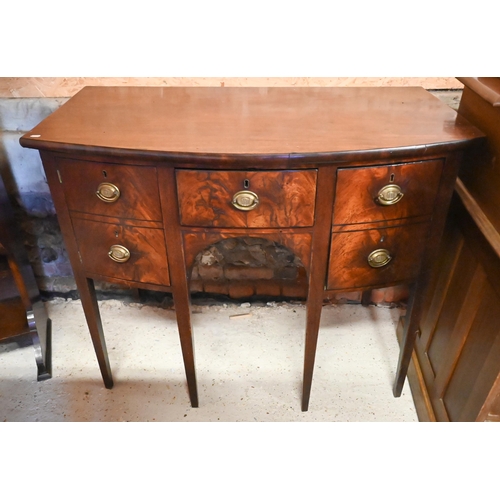 258 - A compact George III mahogany bowfront sideboard, centred by a drawer over an arched apron and flank... 