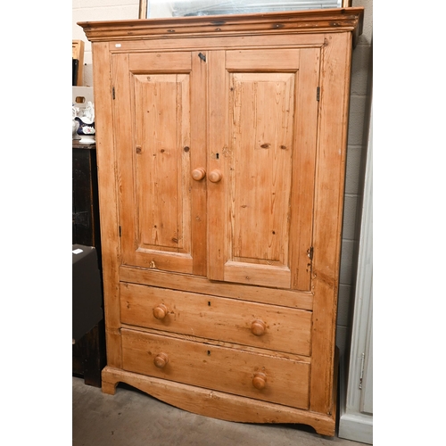 263 - A waxed pine cupboard with panelled cupboards over two drawers, 110 cm wide x 55 cm deep x 162 cm hi... 