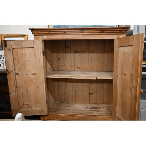 263 - A waxed pine cupboard with panelled cupboards over two drawers, 110 cm wide x 55 cm deep x 162 cm hi... 