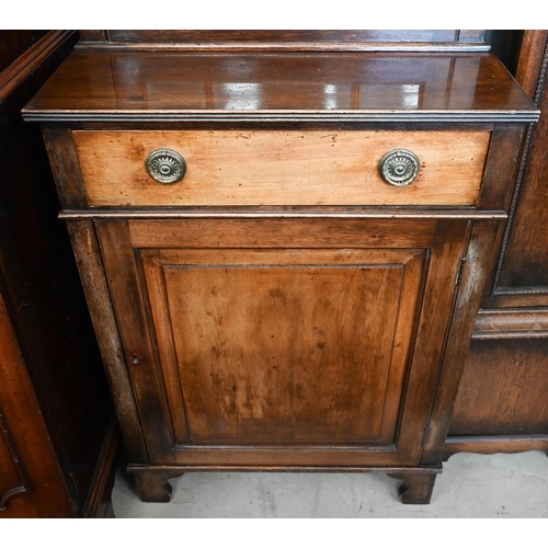 270 - A small mahogany cabinet bookcase, the top with astragal glazed door enclosing three shelves over dr... 