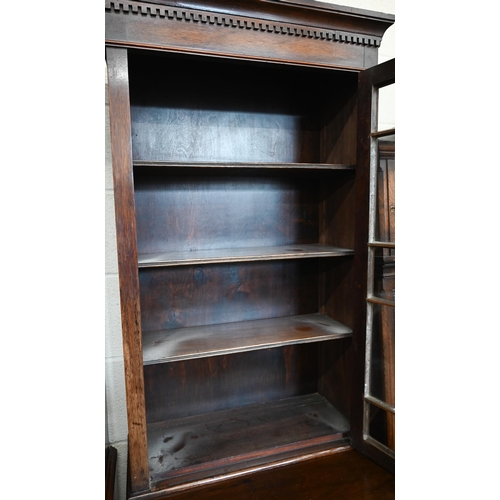 270 - A small mahogany cabinet bookcase, the top with astragal glazed door enclosing three shelves over dr... 