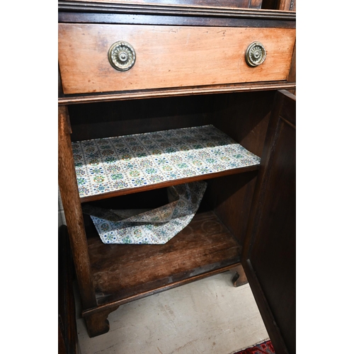 270 - A small mahogany cabinet bookcase, the top with astragal glazed door enclosing three shelves over dr... 