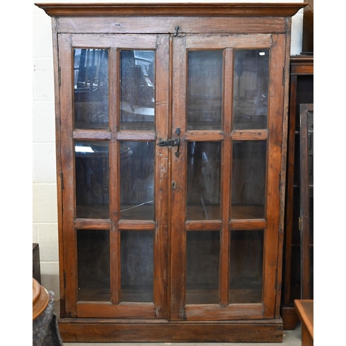 275 - A rustic stained hardwood cabinet with glazed doors (one pane cracked), 120 cm wide x 50 cm deep x 1... 