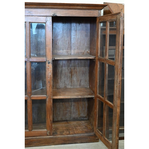 275 - A rustic stained hardwood cabinet with glazed doors (one pane cracked), 120 cm wide x 50 cm deep x 1... 