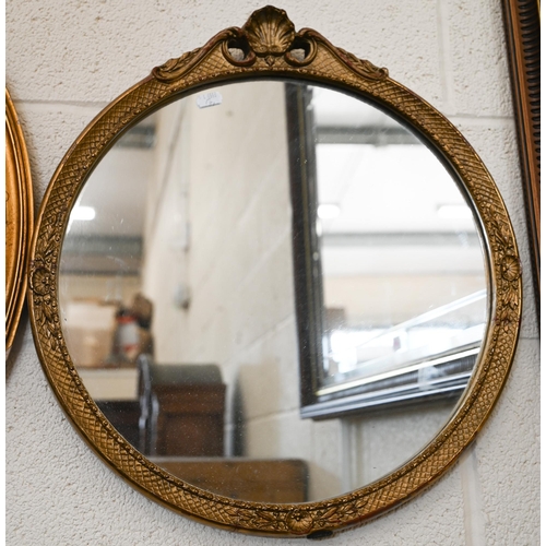 279 - A vintage French style wall mirror in decorative gilt frame. 44 cm diam to/w a gilt framed oval mirr... 