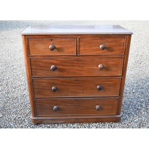 28 - A Victorian mahogany chest of two short over three long graduated drawers with turned handles, the b... 