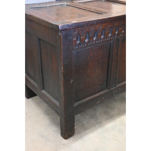 282 - An antique carved oak coffer with hinged top, panelled construction, 114 cm x 55 cm deep x 68 cm hig... 