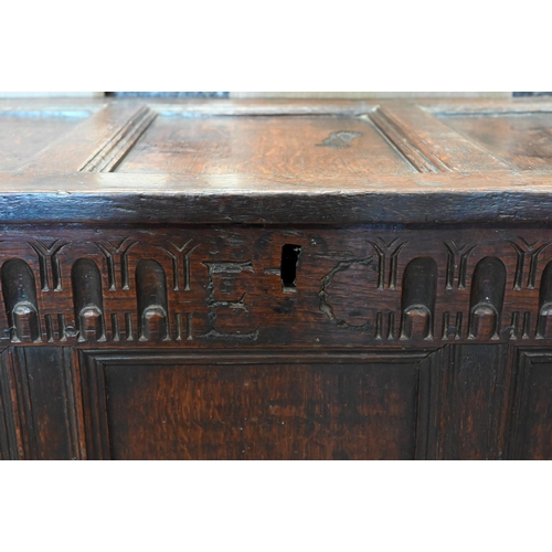 282 - An antique carved oak coffer with hinged top, panelled construction, 114 cm x 55 cm deep x 68 cm hig... 