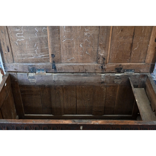 282 - An antique carved oak coffer with hinged top, panelled construction, 114 cm x 55 cm deep x 68 cm hig... 