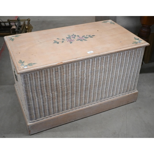 287 - A lime-washed floral painted beech blanket chest with wicker panelled sides and brass handles, 90 cm... 