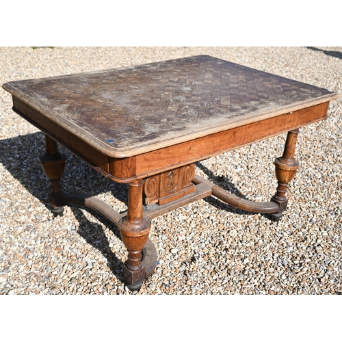 288 - A 19th century French oak dining table with parquetry top, turned supports united by curved stretche... 